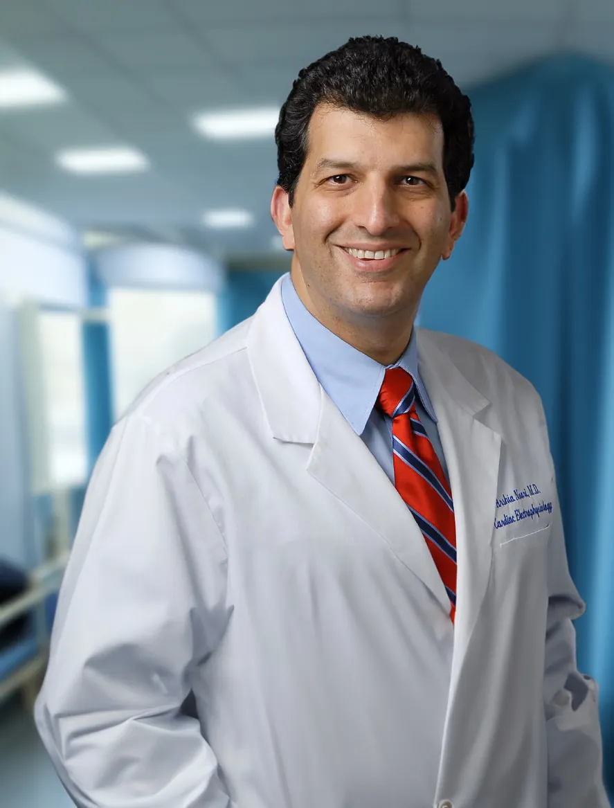 Dr. Arshia Noori, cardiac electrophysiologist, in a white coat